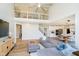 Open floor plan with living room, kitchen, dining area, balcony, and staircase with contemporary black railings at 13933 Wildcat Dr, Carmel, IN 46033