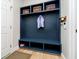 A mudroom with a storage bench, coat hooks, and storage baskets for a tidy and organized space at 13933 Wildcat Dr, Carmel, IN 46033