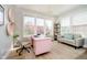 Stylish office with natural light, modern pink desk, and cozy seating area at 13933 Wildcat Dr, Carmel, IN 46033