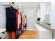 Well-organized walk-in closet with built-in shelves, hanging rods, and wood flooring at 13933 Wildcat Dr, Carmel, IN 46033