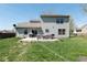 Spacious backyard featuring a patio with outdoor furniture and a well-maintained lawn, perfect for outdoor activities at 13971 Bruddy Dr, Fishers, IN 46038