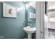 Stylish powder room features a modern pedestal sink and elegant decor for guests at 13971 Bruddy Dr, Fishers, IN 46038