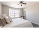 Comfortable bedroom featuring a ceiling fan, soft natural light, and cozy decor at 13971 Bruddy Dr, Fishers, IN 46038