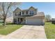 Traditional two-story home with a manicured lawn, attached garage, and charming front porch under a blue sky at 13971 Bruddy Dr, Fishers, IN 46038