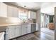 Sunlit kitchen features stainless appliances, white cabinets, and seamless flow to the living area at 13971 Bruddy Dr, Fishers, IN 46038