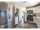 Bright kitchen features stainless steel appliances, white cabinetry, and durable wood-look flooring at 13971 Bruddy Dr, Fishers, IN 46038