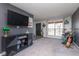 Relaxing living room featuring carpet, front door, a TV, and natural light from a window at 13971 Bruddy Dr, Fishers, IN 46038