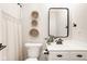 Clean bathroom featuring a white vanity, black accents, and decorative wall baskets at 15037 Rutherford Dr, Westfield, IN 46074