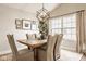Elegant dining room with a wooden table, upholstered chairs, geometric light fixture, and ample natural light at 15037 Rutherford Dr, Westfield, IN 46074