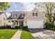 Charming two-story home featuring a covered porch, manicured lawn, and a two-car garage at 15037 Rutherford Dr, Westfield, IN 46074