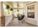 Spacious covered front porch with comfortable seating and hanging plants, offering a relaxing outdoor space at 15037 Rutherford Dr, Westfield, IN 46074