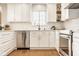 Clean kitchen featuring white cabinets, stainless steel appliances, subway tile backsplash, and hardwood floors at 15037 Rutherford Dr, Westfield, IN 46074