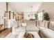 Inviting living room featuring a plush sectional sofa, modern light fixture, and elegant decor throughout at 15037 Rutherford Dr, Westfield, IN 46074