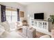 Bright living room features modern furniture, an area rug, and a large tv at 15037 Rutherford Dr, Westfield, IN 46074