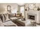 Comfortable living room featuring a fireplace, neutral decor, and large sectional couch for a cozy feel at 15037 Rutherford Dr, Westfield, IN 46074