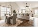 Open-concept living room with a vaulted ceiling, wood floors, and a dining area for modern living at 15037 Rutherford Dr, Westfield, IN 46074