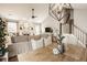 Open-concept living room with a fireplace, sectional sofa, dining area, and staircase to the second floor at 15037 Rutherford Dr, Westfield, IN 46074