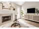 Bright living room featuring a fireplace, modern entertainment center, and an adjacent outdoor entry at 15037 Rutherford Dr, Westfield, IN 46074