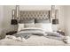 Close up of the main bedroom showcasing the tufted headboard, decorative pillows, and soft textures at 15037 Rutherford Dr, Westfield, IN 46074