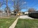 Backyard featuring a grassy area, gravel parking, and a mix of wooden and chain-link fencing at 1517 N Gladstone Ave, Indianapolis, IN 46201