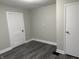 Bedroom featuring gray walls, new flooring, and a spacious closet at 1517 N Gladstone Ave, Indianapolis, IN 46201