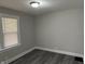 Bedroom featuring gray walls and new flooring, with a view of the room's window at 1517 N Gladstone Ave, Indianapolis, IN 46201