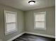Bright bedroom with new flooring, neutral paint, and natural light from two windows at 1517 N Gladstone Ave, Indianapolis, IN 46201