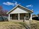 Charming home with a stone front, covered porch, and manicured lawn on a sunny day at 1517 N Gladstone Ave, Indianapolis, IN 46201