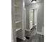 Hallway with modern flooring that leads to the bathroom and utility area, offering ample storage at 1517 N Gladstone Ave, Indianapolis, IN 46201