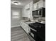 Well-equipped kitchen with black appliances, stylish cabinets, and granite countertops at 1517 N Gladstone Ave, Indianapolis, IN 46201