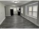Open-concept living area showcasing new flooring, modern paint, and an adjoining kitchen at 1517 N Gladstone Ave, Indianapolis, IN 46201
