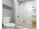 Modern bathroom with glass enclosed shower, tiled floor, and a wooden bench at 1520 Norfolk Dr, Zionsville, IN 46077