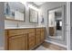 Bathroom featuring dual sinks, wood cabinets, and a large mirror for extra space at 1520 Norfolk Dr, Zionsville, IN 46077