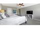 Bedroom featuring a ceiling fan, gray carpet, and mounted TV at 1520 Norfolk Dr, Zionsville, IN 46077