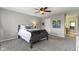Bedroom with ceiling fan, gray carpet, and an ensuite bathroom at 1520 Norfolk Dr, Zionsville, IN 46077
