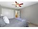 Bedroom with ceiling fan, closet, gray bedding, and ensuite bathroom access at 1520 Norfolk Dr, Zionsville, IN 46077