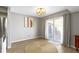Dining area with sliding glass doors to the patio, a modern light fixture, and neutral decor at 1520 Norfolk Dr, Zionsville, IN 46077