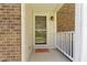 Close up of front porch with detailed brickwork, modern lighting fixture, and welcoming features at 1520 Norfolk Dr, Zionsville, IN 46077