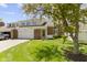 Brick townhouse with an attached garage, well-kept lawn, mature trees, and a cozy, welcoming ambiance at 1520 Norfolk Dr, Zionsville, IN 46077