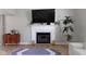 Close-up of a living room fireplace with modern decor, wooden floors, and neutral wall color at 1520 Norfolk Dr, Zionsville, IN 46077