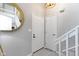 Bright foyer featuring modern fixtures, white trim, round mirror and an adjacent coat closet at 1520 Norfolk Dr, Zionsville, IN 46077