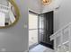 Bright foyer featuring modern fixtures, white trim, a round mirror, and an open view to the interior at 1520 Norfolk Dr, Zionsville, IN 46077