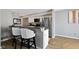 Modern kitchen featuring stainless steel appliances, a breakfast bar with stylish seating, and gray countertops at 1520 Norfolk Dr, Zionsville, IN 46077