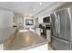 Bright kitchen with stainless steel appliances, granite countertops, and a view into the dining area at 1520 Norfolk Dr, Zionsville, IN 46077