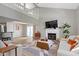 Bright living room with fireplace, high ceilings, neutral tones, wood floors, and modern decor at 1520 Norfolk Dr, Zionsville, IN 46077