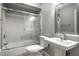 Full bathroom featuring tiled shower-tub, glass doors, modern fixtures, and pedestal sink at 156 Aspen Way, Carmel, IN 46032