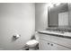 Well-lit bathroom features granite counters, white vanity, modern toilet and decorative framed mirror at 156 Aspen Way, Carmel, IN 46032