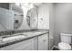 Bright bathroom showcasing double vanity with granite counters, oval mirrors, and white cabinets at 156 Aspen Way, Carmel, IN 46032