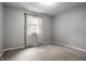 This carpeted bedroom features a window with bright natural light and neutral walls at 156 Aspen Way, Carmel, IN 46032