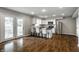 Open concept kitchen with stainless steel appliances, bar seating, and doors to an outdoor patio at 156 Aspen Way, Carmel, IN 46032